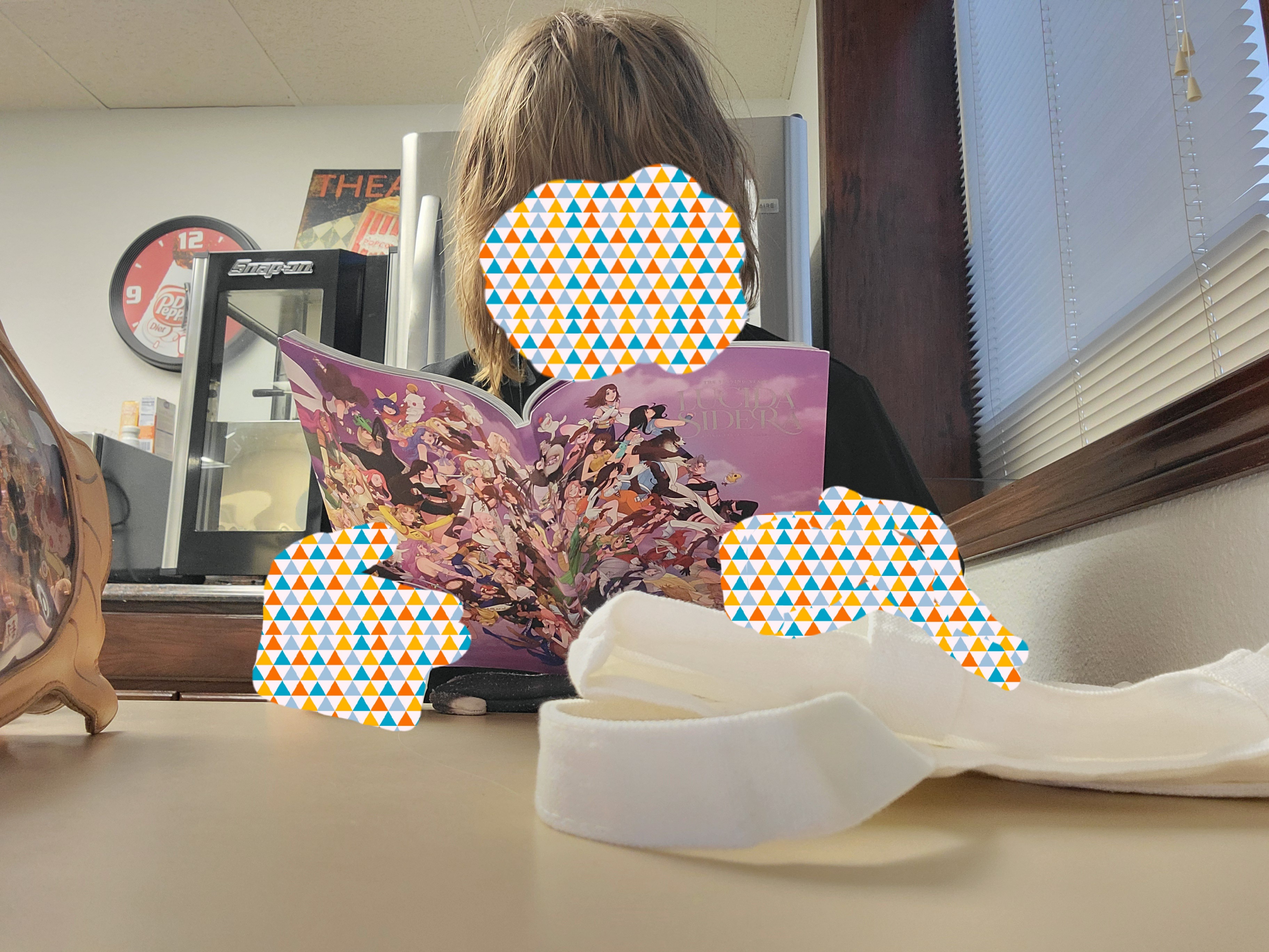 Girl reads fan zine with various female Final Fantasy characters on the cover.